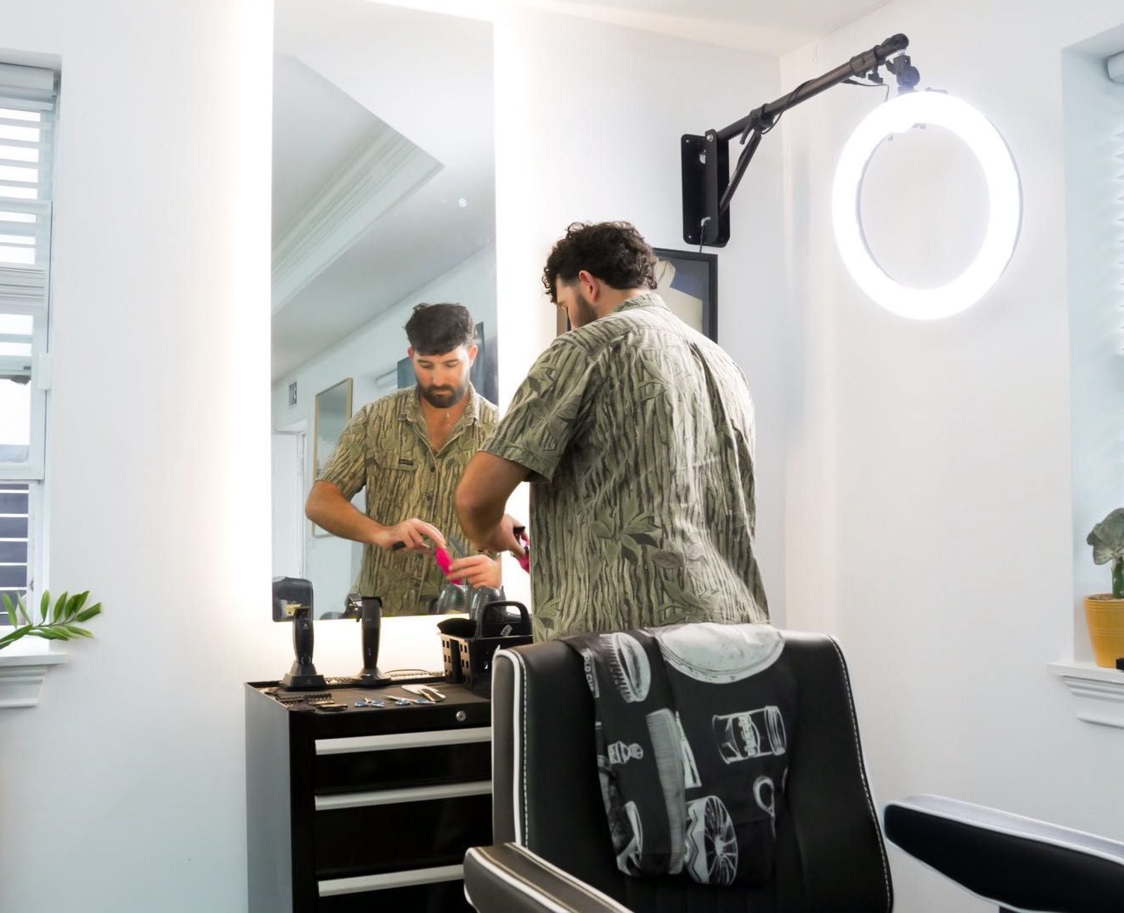 A barber at work inside Dutch Cuts